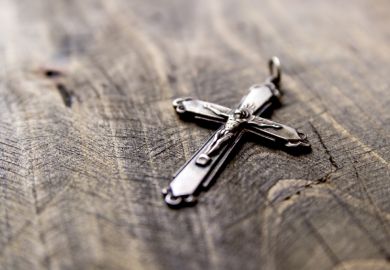 Christian cross on table