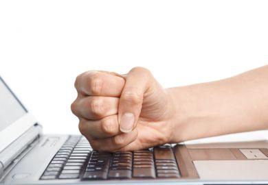 Man hitting keyboard with fist