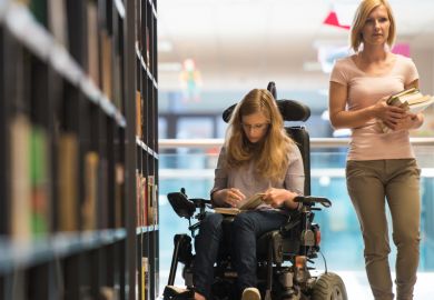Woman in wheelchair in library