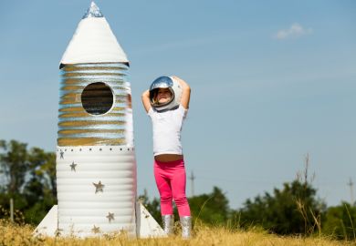 Happy child dressed in an astronaut costume