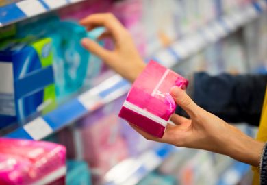 Woman choosing feminine hygiene products in supermarket Woman choosing feminine hygiene products in supermarket