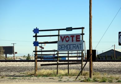 Sign supporting the Democratic Party on a shabby rack beside the road