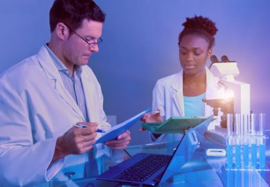 istock A senior white scientist and a junior black scientist A senior white scientist and a junior black scientist