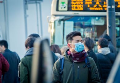 Man wearing mask on the street at rush hour in Japan