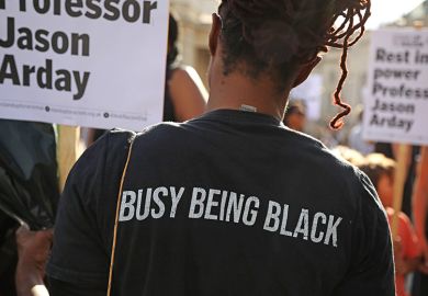 An attendee, wearing a T-shirt stating “busy being black”, holds a placard during a vigil for former Cambridge professor Jason Arday in Trafalgar Square on 17 August 2026 in London, United Kingdom. An attendee, wearing a T-shirt stating “busy being black”, holds a placard during a vigil for former Cambridge professor Jason Arday in Trafalgar Square on 17 August 2026 in London, United Kingdom.
