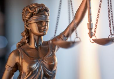 A statue of justice A statue of justice illustrating opinion article about double-blind peer review