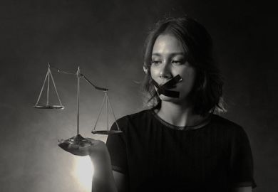 A woman wide tape over her mouth holds uneven scales of justice