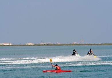Kayaker and jet skiiers