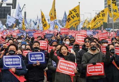 South Korean doctors hold placards saying "Opposition to the increase in medical schools" South Korean doctors hold placards saying "Opposition to the increase in medical schools" to illustrate Row over doctors’ training thwarts Korean president
