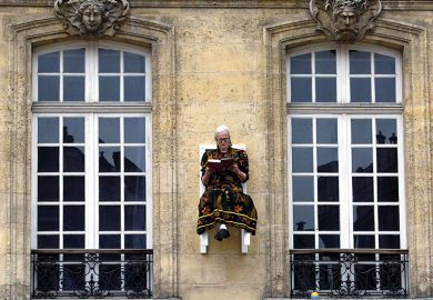 Woman sitting on wall