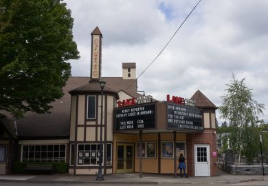 Lake Oswego, OR, USA - July 4, 2020: The cinema billboard at Lake Theater in downtown Lake Oswego shows the numbers of newly reported COVID-19 cases in Oregon.
