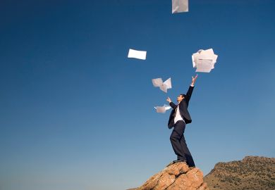 man throws papers in the air