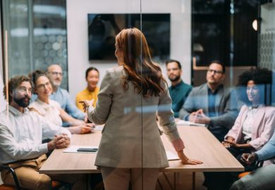 A woman gives a seminar, illustrating leadership