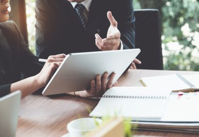 A lawyer offers advice to a student