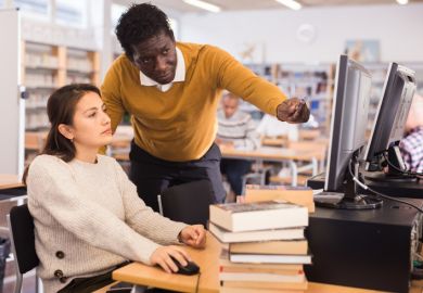 A librarian helping a student