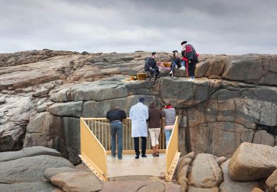 People looking across The Gap, Albany, Western Australia. On the other side, academics are having a picnic. To illustrate the difference in the remuneration of academics compared with those with specialist expertise. People looking across The Gap, Albany, Western Australia. On the other side, academics are having a picnic. To illustrate the difference in the remuneration of academics compared with those with specialist expertise.