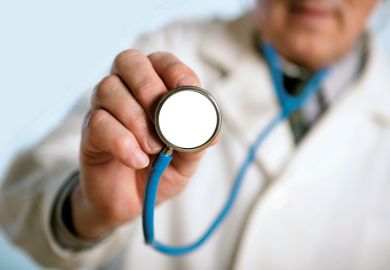 Male doctor holding stethoscope Male doctor holding stethoscope