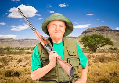 Male hunter holding shotgun