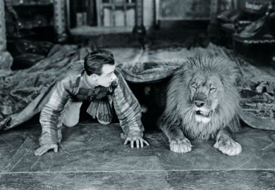 Man and lion lying beneath rug