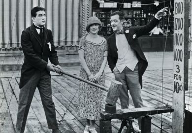 Man attempting strength test at amusement park Man attempting strength test at amusement park