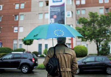 Man carrying a European Union (EU)-branded umbrella Man carrying a European Union (EU)-branded umbrella