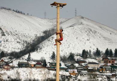 Man climbing wooden column, Krasnoyarsk, Siberia