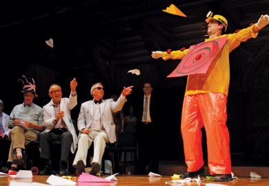 Man dressed as target hit by thrown paper aeroplanes Man dressed as target hit by thrown paper aeroplanes