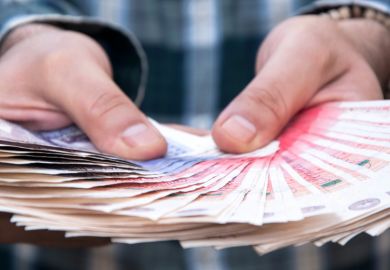 Man holding fan of British fifty pound notes Man holding fan of British fifty pound notes