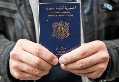 Man holds Syrian passport, Luebeck, Germany, 2015