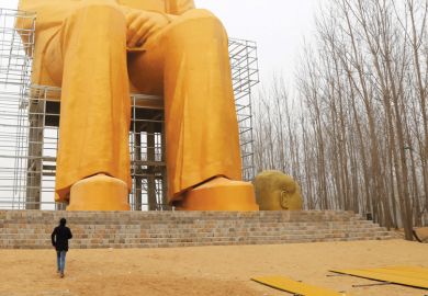 Man looking at statue of Mao Zedong, China, 2016