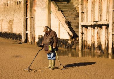 Man metal detecting on beach Man metal detecting on beach