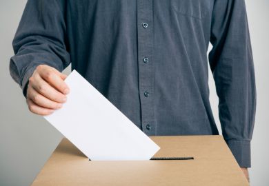 Man putting vote in ballot box
