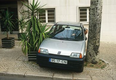 Man reverses his car into a narrow space Man reverses his car into a narrow space