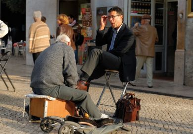 Man shining the shoes of a businessman