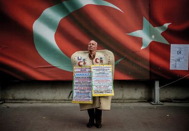 Man standing in front of Turkish national flag