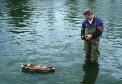 Man using remote-controlled boat