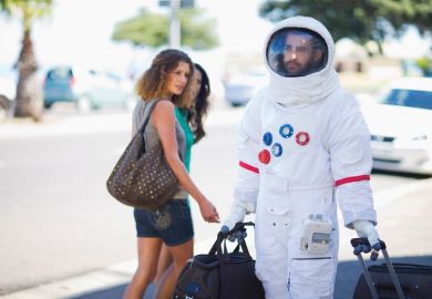 Man walking on street dressed as astronaut