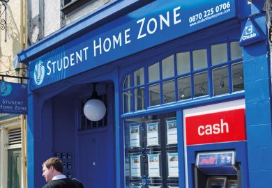 Man walking past Student Home Zone office
