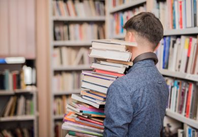 Man carrying lots of books