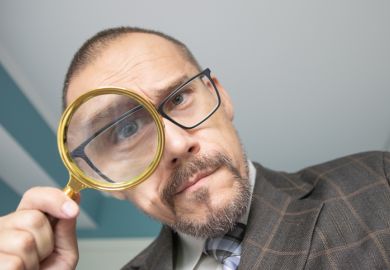 Man looking through a magnifying glass