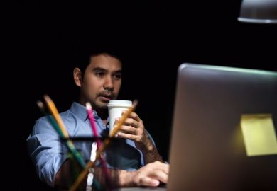 Man working at computer in evening