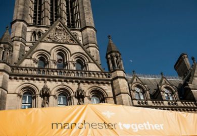 A banner on Manchester town hall reading "Manchester Together", commemorating the anniversary of the Manchester Arena bomb.