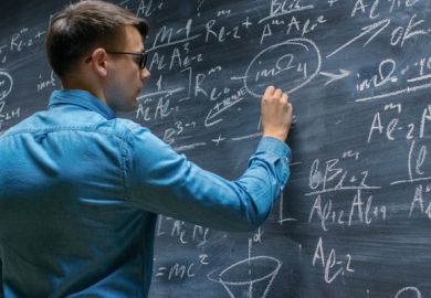 A mathematician works on the blackboard