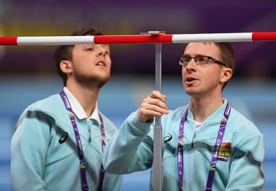 Officials measure the High Jump bar during the IAAF Athletics World Indoor Championships at Arena Birmingham, UK. To illustrate setting the bar for REF submissions..