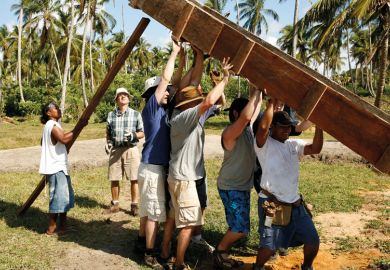 Men lifting wooden construction frame, Tasbapauni, Nicaragua