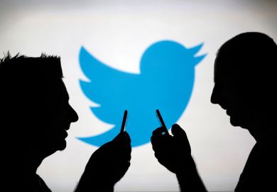 Men using smartphones against Twitter logo backdrop