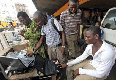Men working on laptops, Obalende District, Lagos, 2010