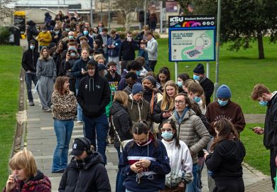 Staff and students, some wearing face masks, queue to receive antibiotics at the University of Kent in Canterbury after an outbreak of meningitis caused the deaths of two people, on 16 March, 2026 in Canterbury, United Kingdom.