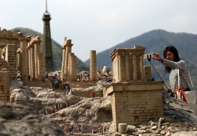 A visitor photographs a scale model of the Parthenon at Tobu World Square theme park in Nikko, Japan. Illustrating a plan to shrink the higher education sector fairly.