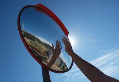 Hand reflecting in a mirror